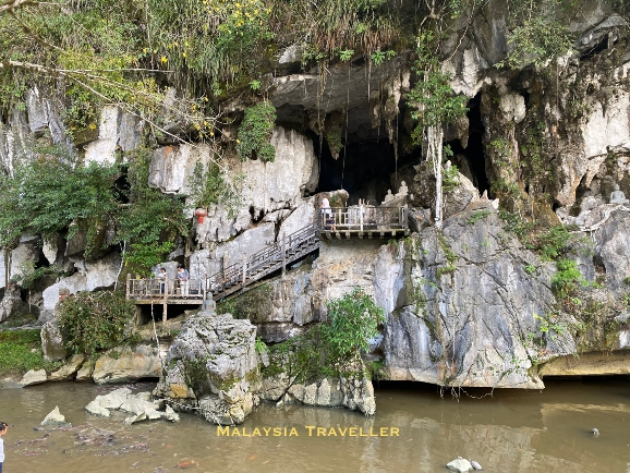 pond and steps in front of the cave entrance