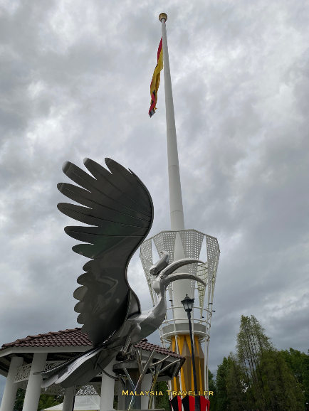 Stainless steel hornbill statue next to flagpole Stainless steel hornbill statue next to flagpole