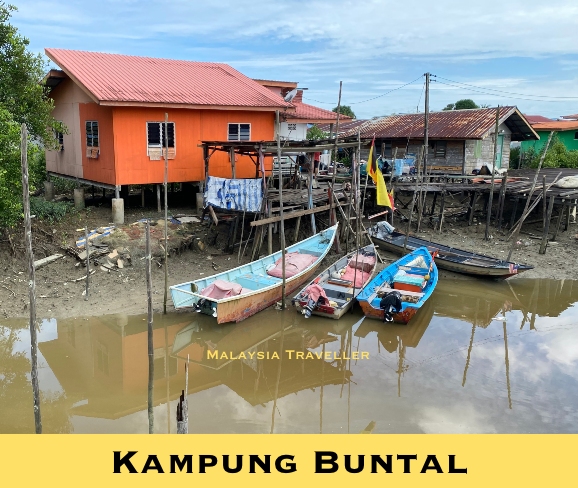 brightly painted house and fishing boats
