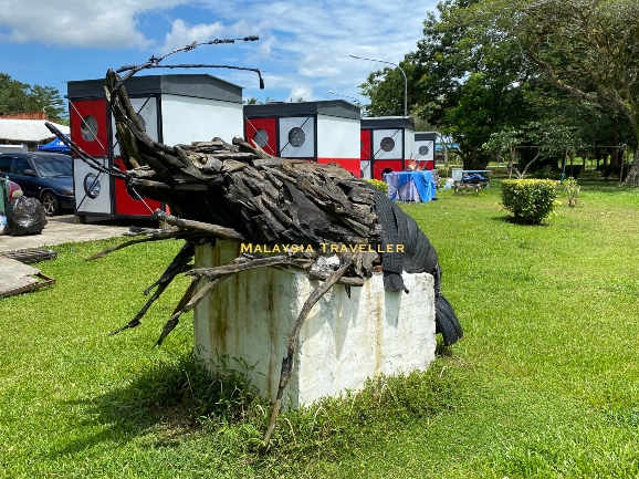 a statue made of driftwood and car tires