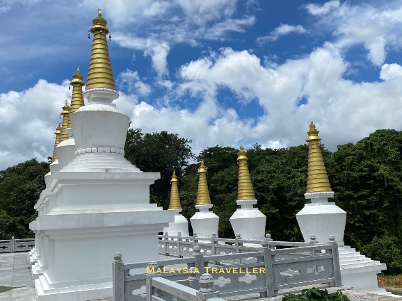 eight white stupas with golden tops