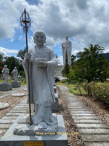 statue of a Buddha disciple with a begging bowl.
