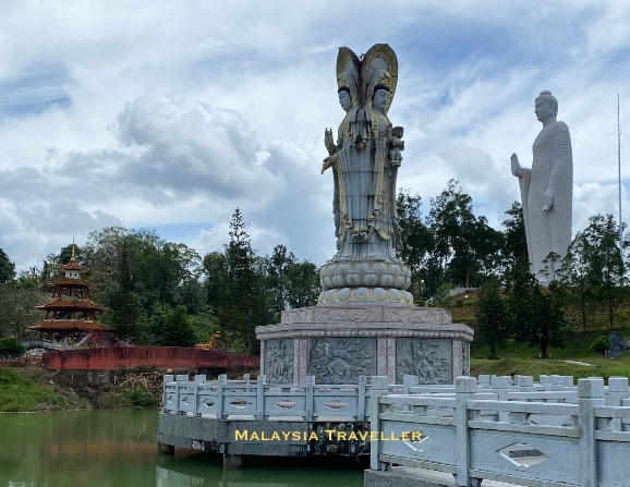 statue of guanyin on an island in a lake
