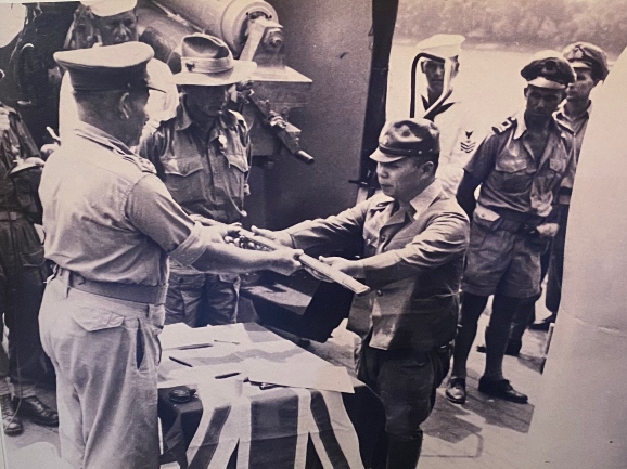 Japanese general handing over samurai sword to Australian general
