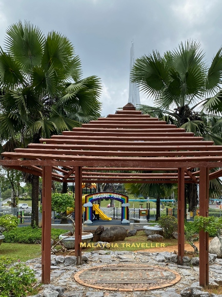 wooden gazebo with childrens playground behind