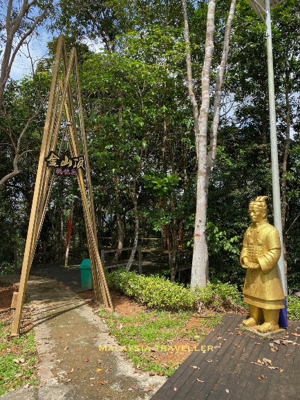 golden terracota statue and entrance to pathway golden terracota statue and entrance to pathway