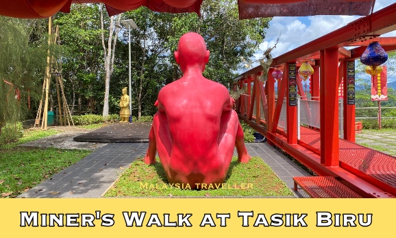 naked sitting red man statue from behind naked sitting red man statue from behind