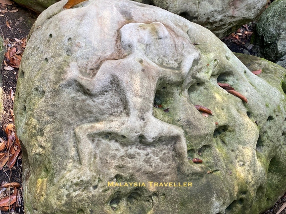 boulder carved with a spread-eagled human figure