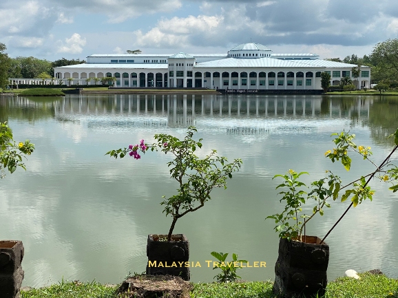huge white library building reflected in the lake