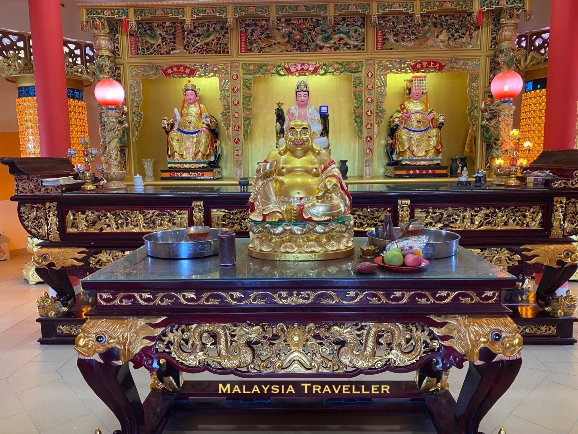 golden maitreya Buddha statue and altar