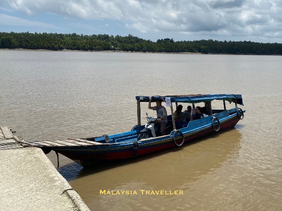sampan ferry boat with motorbike on board