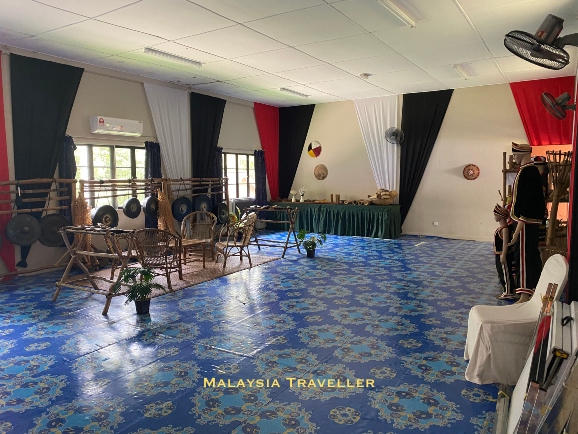 interior of mini museum with gongs and costumes