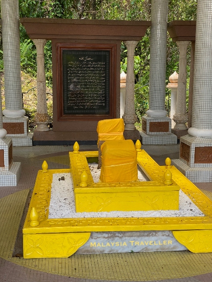 yellow coloured tomb with gravestones wrapped in yellow cloth