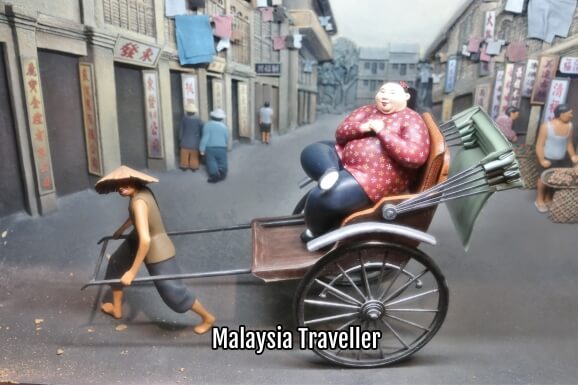 figurine of fat Chinese lady being pulled by rickshaw figurine of fat Chinese lady being pulled by rickshaw