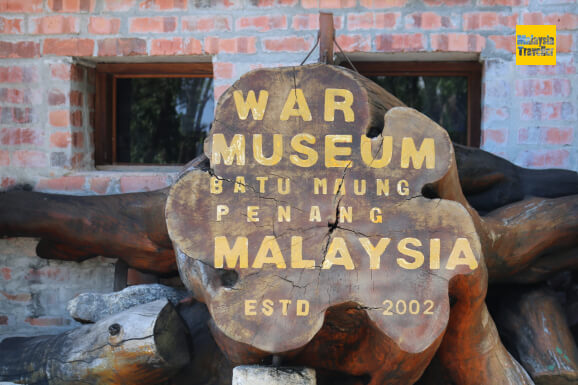 sign painted on tree stump at Penang War Museum sign painted on tree stump at Penang War Museum